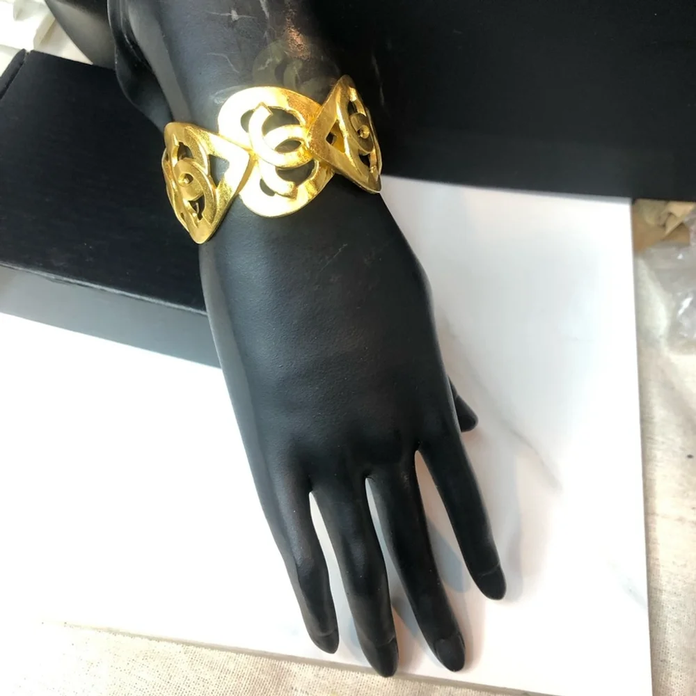 CHANEL Gold Cuff Bracelet with Interlocking CC Open Heart Design